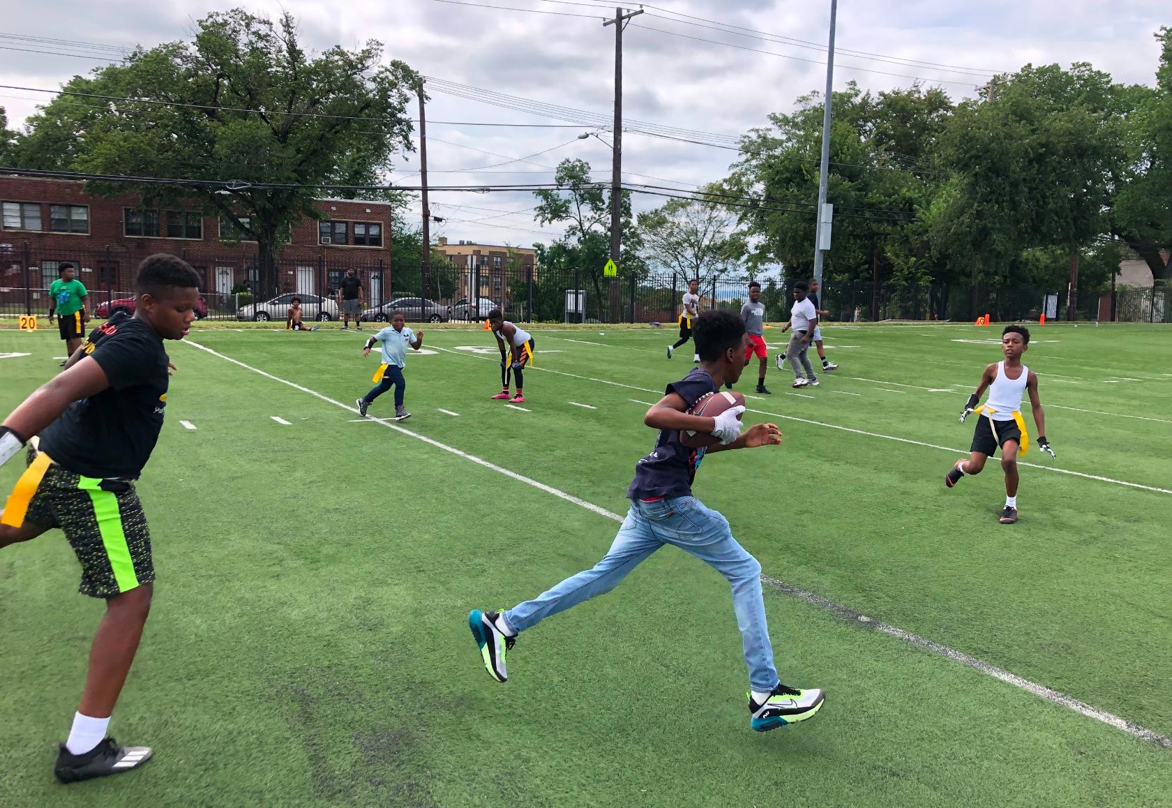 Kids playing on a grassy athletic field