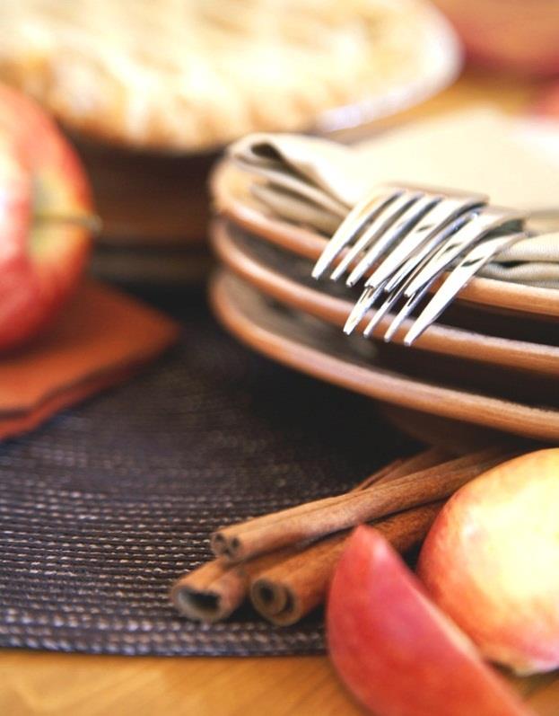 Fresh apples and cinnamon on a kitchen table